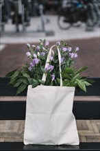 White cotton handbag with beautiful purple eustoma flowers