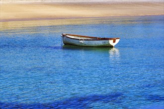 White rowboat on the shore