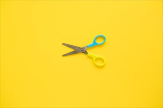 Opened scissors laid middle