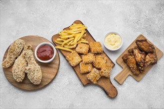 Top view fried chicken nuggets sauces chopping boards