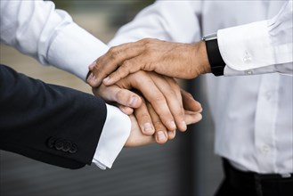 Businessmen with hands together