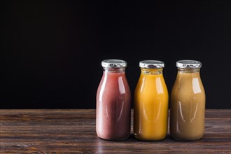 Smoothie bottles wooden surface