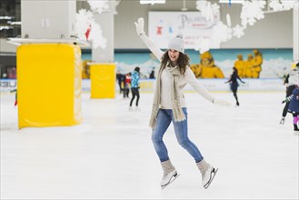 Cheerful woman skating rink