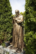 Statue of Padre Pio in front of the pilgrimage church Maria Himmelfahrt in Sammarei