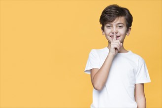 Young boy showing sign silence