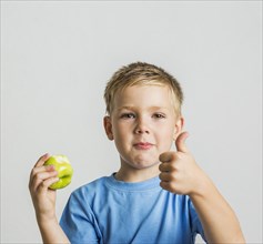 Front young boy with green apple
