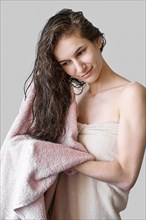Portrait woman drying hair with towel