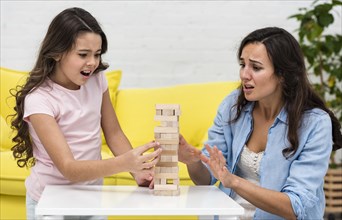 Mother playing with her daughter boarding game