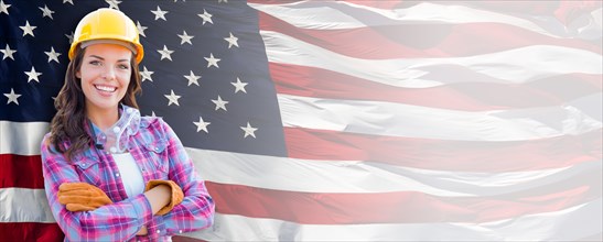 Female contractor wearing blank yellow hardhat and gloves over waving american flag background banner