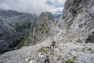 Mountaineer in steep rocky terrain on the way to Waxenstein