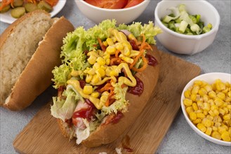 High angle hot dog with salad corn