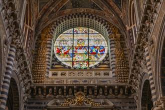 Coloured round window in the cathedral with filigree decoration