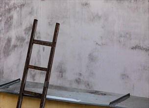 Stepladder leaning against a backyard facadein the historic old town of Ceske Budejovice