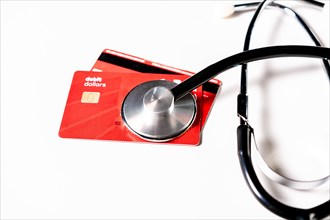Stethoscope on isolated credit card. Online healthcare payment concept