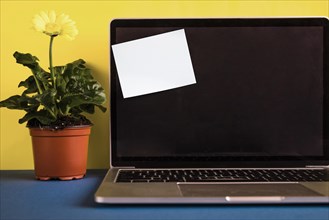 Laptop with post it note opened lid