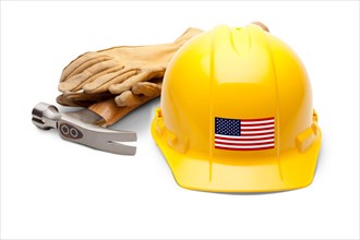 Yellow hardhat with an american flag decal on the front with hammer and gloves isolated on white background