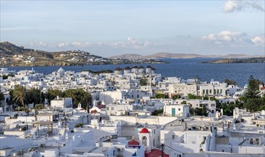 View over white Cycladic houses and windmills