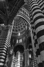 Black and white striped marble columns in the cathedral below the dome with starry sky