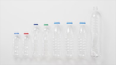 Various types plastic bottles grey background
