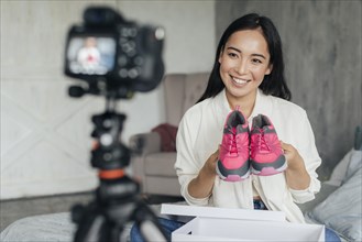 Woman vlogging with her sports shoes