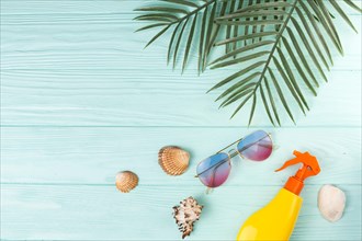 Tropical leaves with beach accessories composition