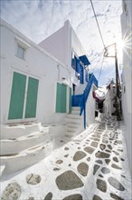 Cycladic white houses with colourful shutters and doors