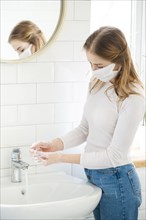 Woman washing her hands bathroom