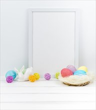 Easter eggs nest with blank frame table