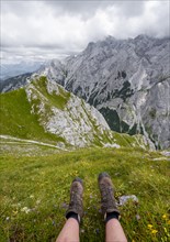 Feet of a female mountaineer with hiking boots