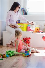 Woman playing with child playroom