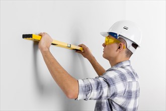 Worker with spirit level wall