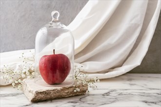 Jar with apple flowers beside