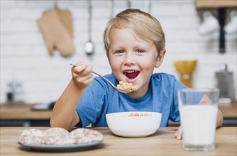 Smiley kid eating cereal