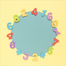 Colourful math numbers frame surrounding blue circular shape