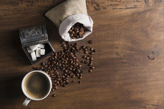 Sack with coffee beans near box sugar cup