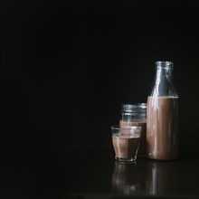 Chocolate milk shake glass jar bottle black background