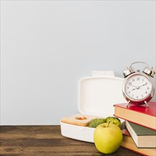 Alarm clock books near healthy food