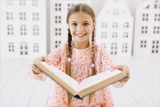 Lovely happy girl posing with book