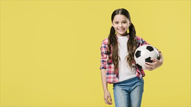 Girl posing with football studio