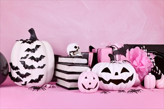 Modern pink Halloween decor with black and white pumpkins