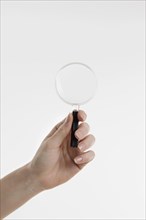 Hand holding magnifying glass with copy space