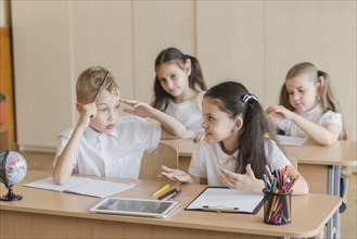 Girl talking with boy during lesson