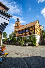 Half-timbered house in front of Buckow parish church