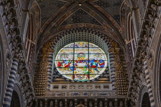 Coloured round window in the cathedral with filigree decoration