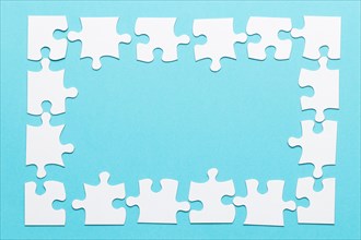 High angle view jigsaw puzzle frame blue backdrop