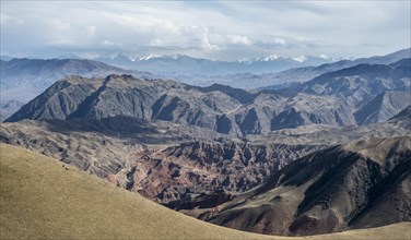 View over eroded mountainous landscape of Konorchek Canyon with red sandstone rocks