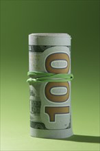 Rolled up banknotes isolated green background