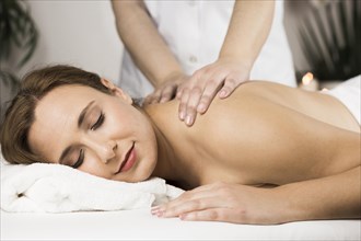 Woman receiving massage spa center
