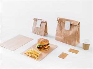 Tasty burger french fries parcels disposal cup white surface