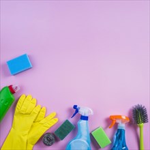 Elevated view cleaning products pink background